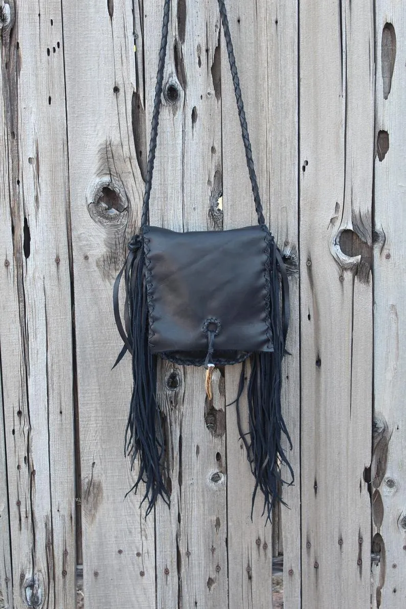 Black leather handbag with fringe and an antler tip closure