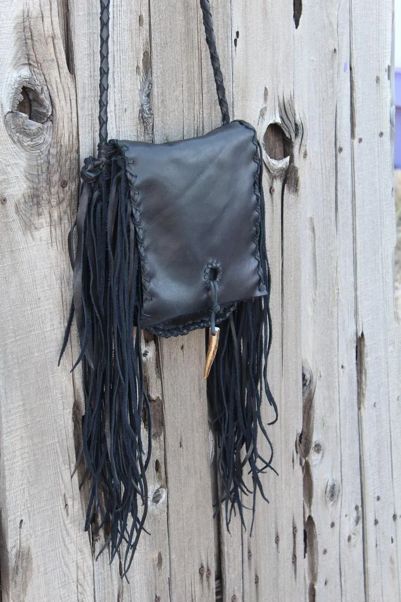 Black leather handbag with fringe and an antler tip closure